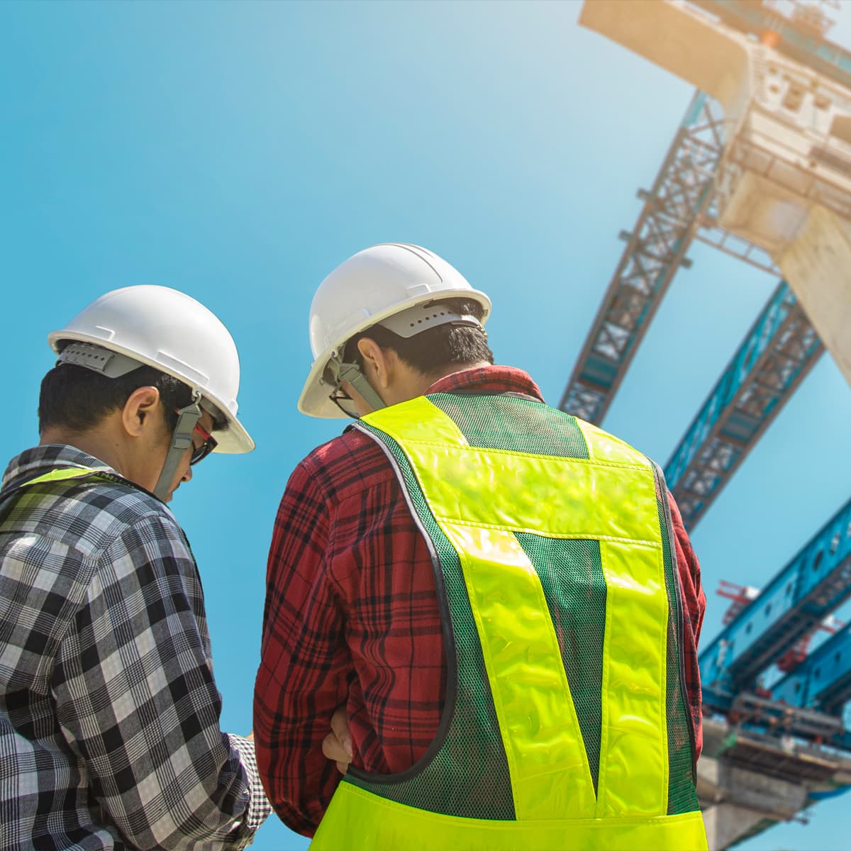 Two Construction Workers Infront of Overpass