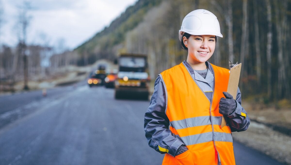 Young Woman With Clipboard On Highway Project