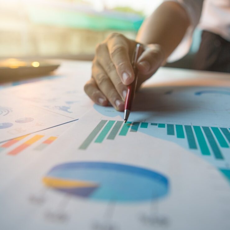 Person writing charts and graphs