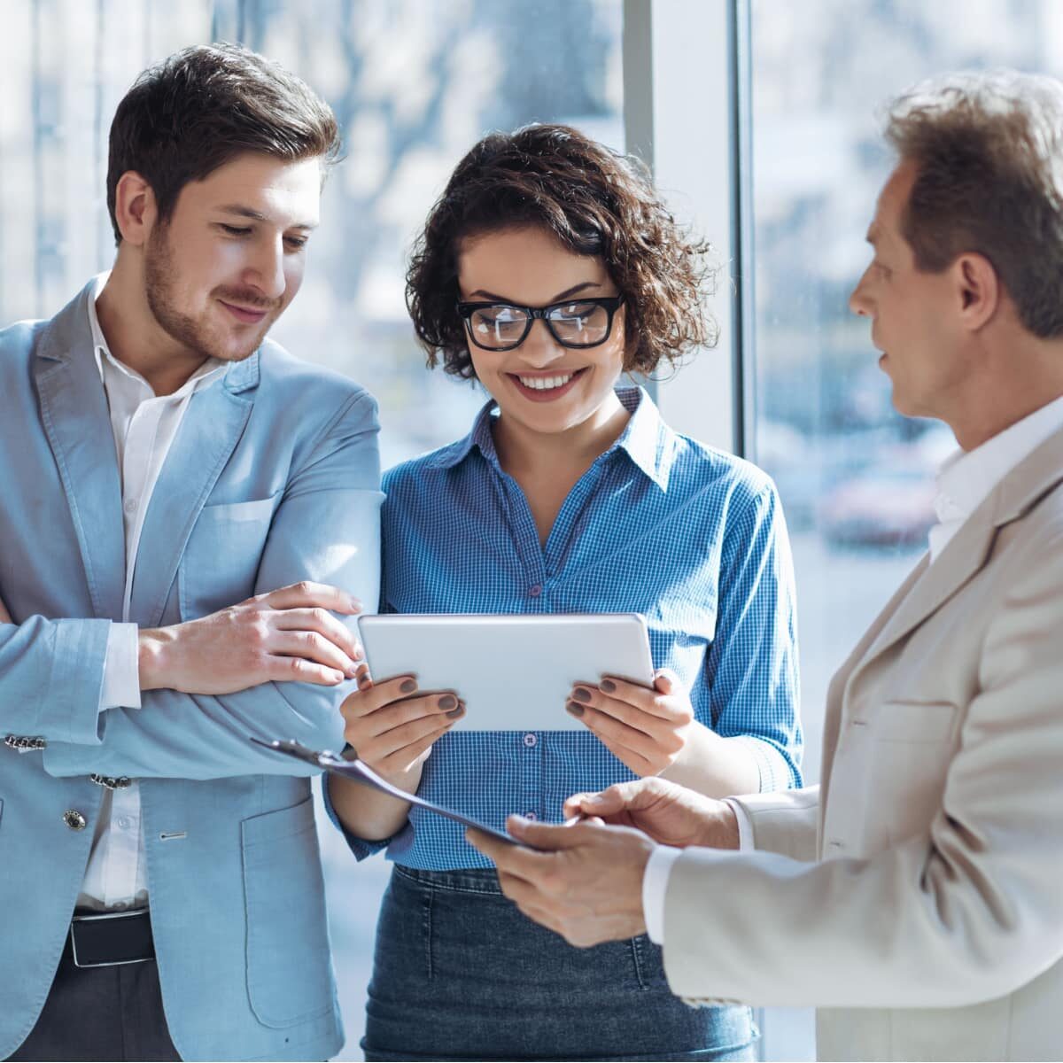 happy business people looking at the tablet
