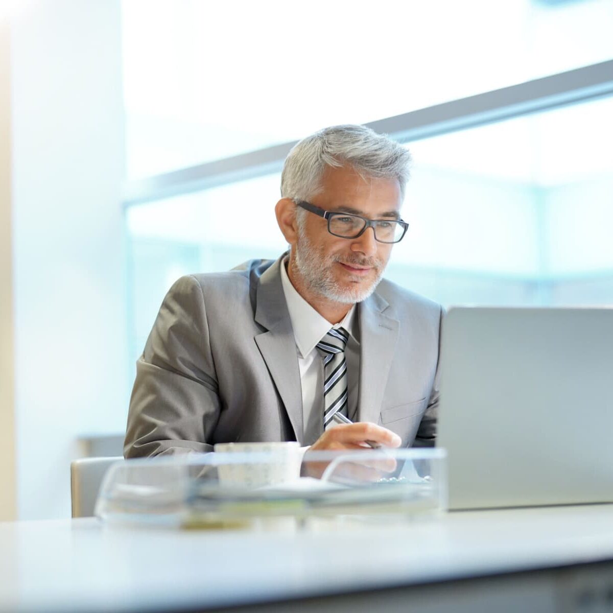 mid-age businessman using his laptop in the office