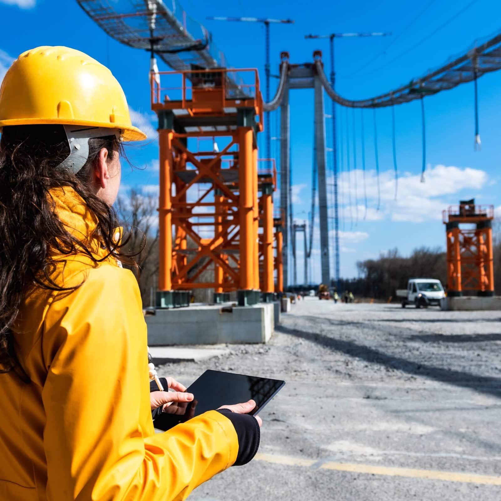 Young,Women,Engineer,At,Work,With,Yellow,Helmet,And,Digital